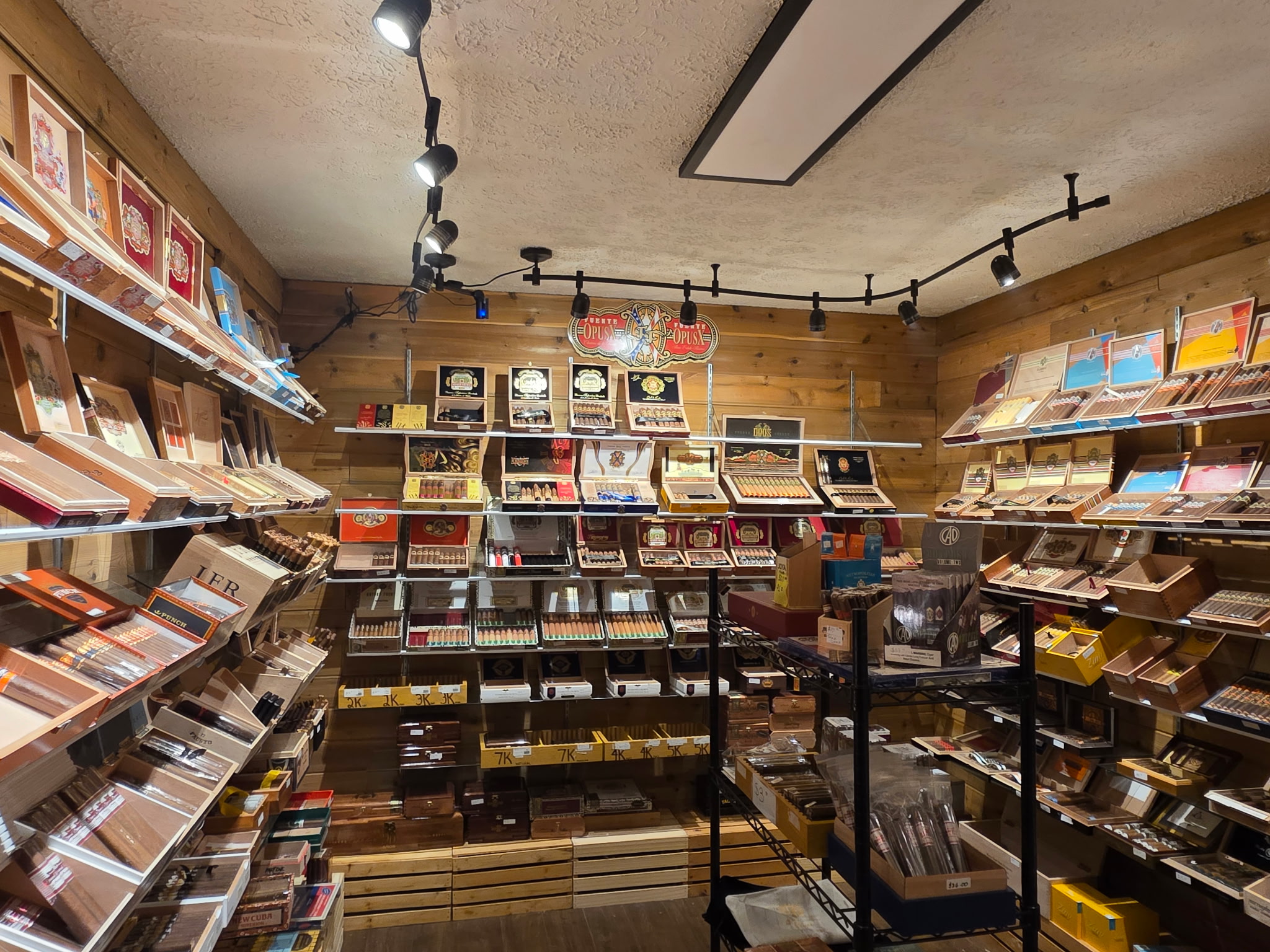 The walk-in humidor at The Office Cigar Lounge stacked with Fuente boxes